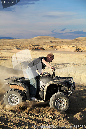 Image of teen riding quad ATV in the hills