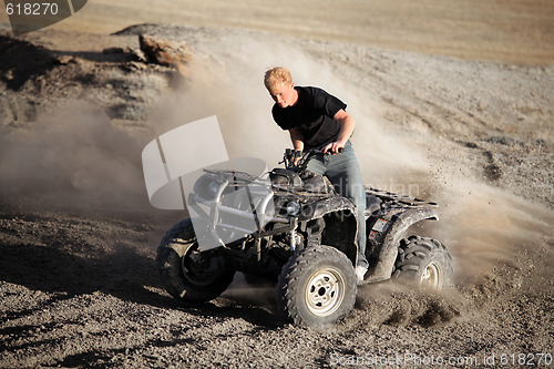 Image of teenager riding quad - four wheeler