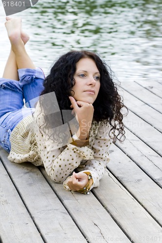 Image of woman lying near the river