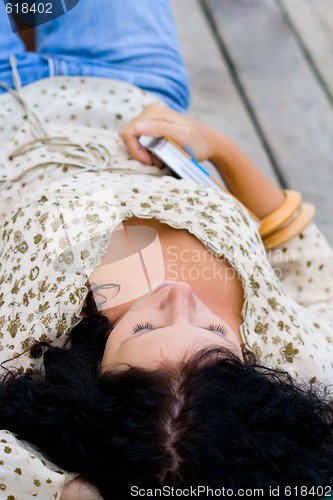 Image of woman lying with book