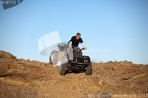 Image of teen on ATV quad in the hills