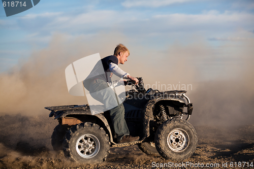 Image of teen riding ATV quad