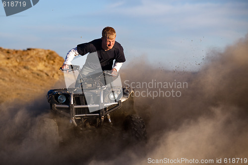 Image of quad ATV kicking up dust