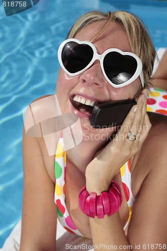 Image of Woman on her Cellphone by the Pool