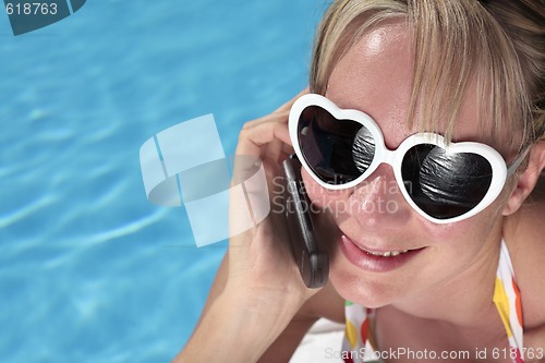 Image of Woman on her Cellphone by the Pool