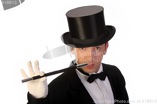 Image of young magician performing with wand 