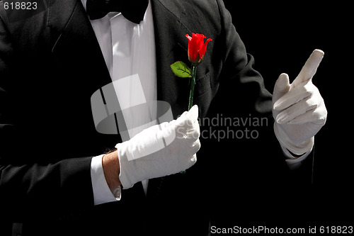 Image of young magician performing red rose