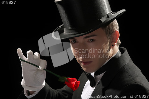 Image of magician performing red rose