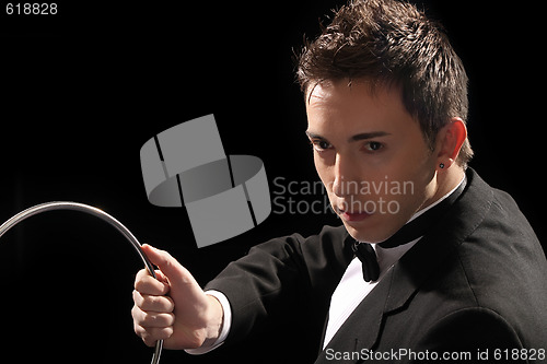 Image of young magician with silver metal rings