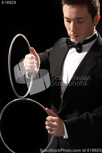 Image of young magician with silver metal rings