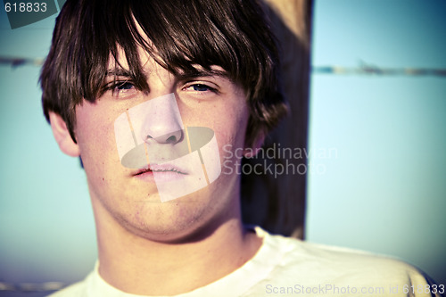 Image of teen against fence