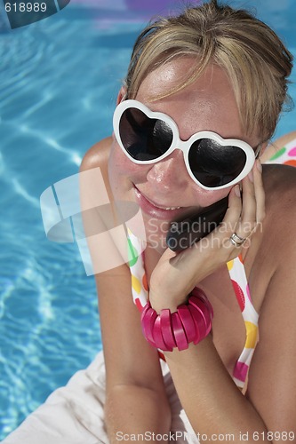 Image of Woman on her Cellphone by the Pool