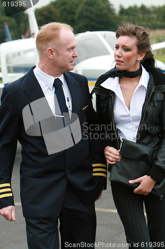 Image of Pilot and young woman in front of a private airplane