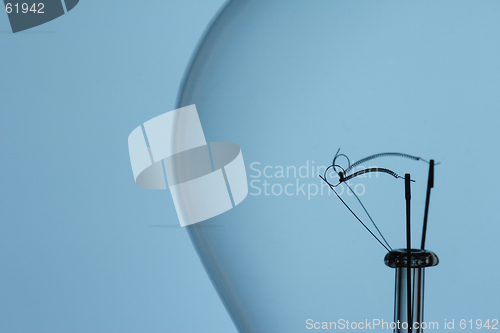 Image of light bulb filament on blue background