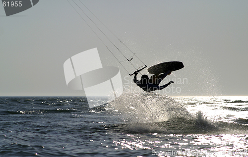 Image of kite boarder jumping on the ocean