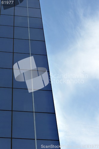 Image of glass office building with blue sky