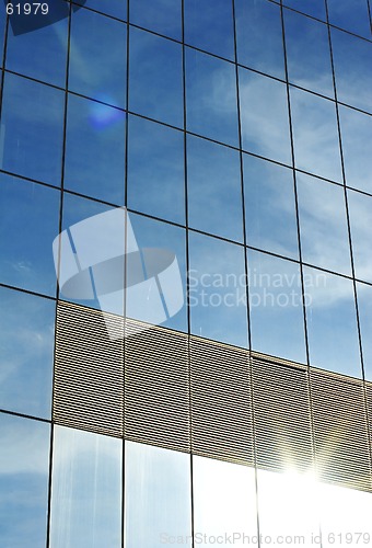 Image of glass office building with reflection of sky