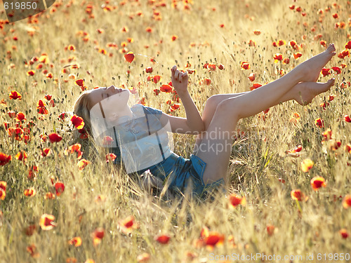 Image of Barefoot blonde in poppies