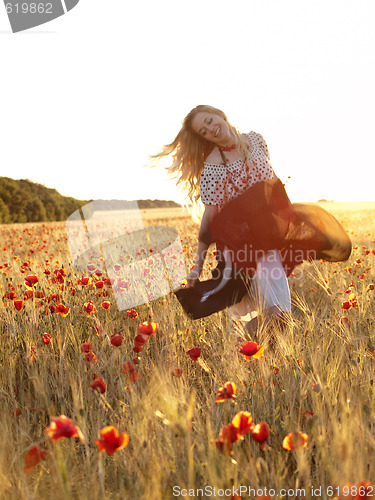 Image of Blonde walking in poppy field