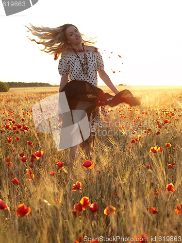 Image of Blonde walking in poppy field