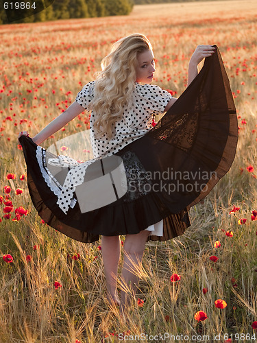 Image of Blonde walking in poppy field