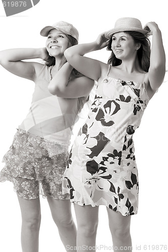 Image of two smiling women in summer dresses