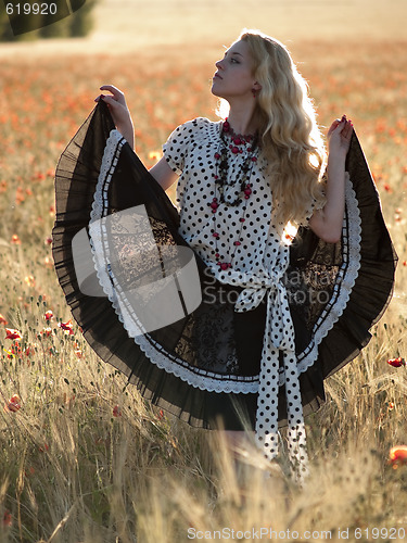 Image of Blonde walking in poppy field