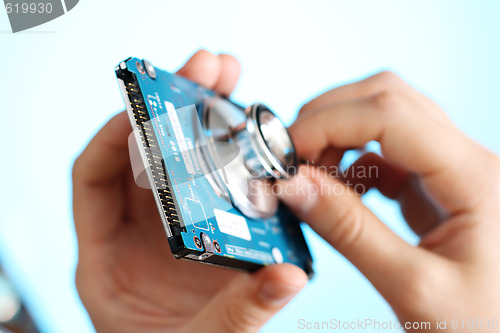 Image of Doctor holding stethoscope at notebook hdd