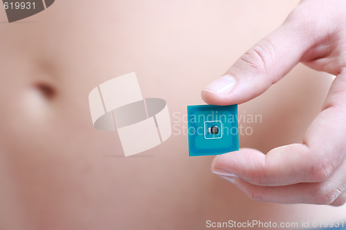 Image of Woman holding Radio-frequency identification (RFID) tag card