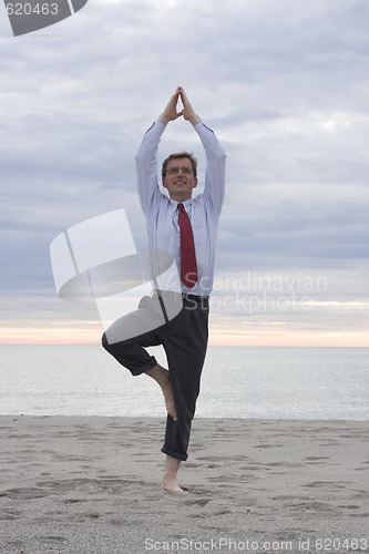 Image of Businessman doing yoga