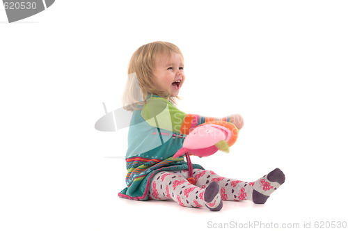 Image of Happy baby sitting on the floor