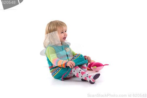 Image of Happy baby sitting on the floor