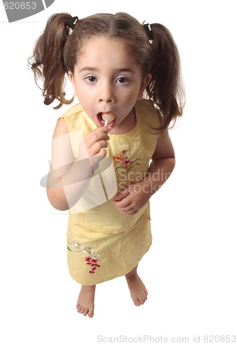 Image of Little girl eating a lollipop candy