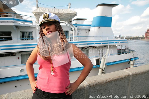 Image of serious girl in captain cap