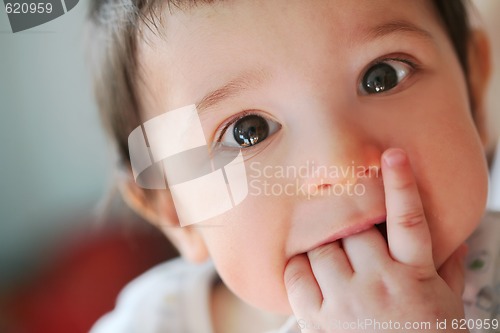 Image of small boy touches their own first teeth