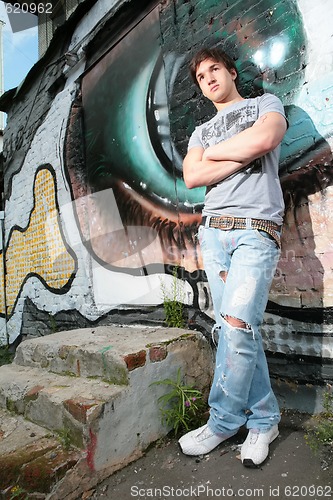 Image of man near graffiti