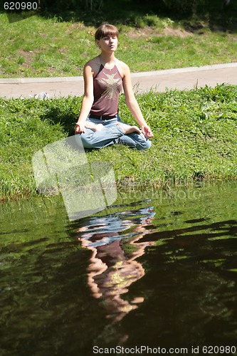 Image of young woman is meditating