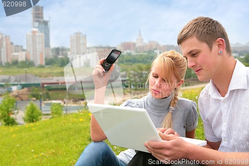 Image of beautiful blond, yong man and computer