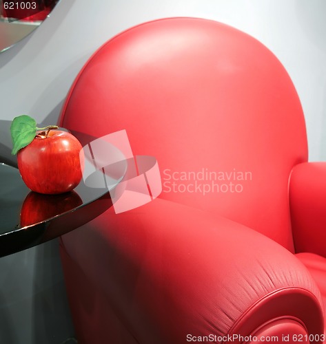 Image of red leather chair and apple