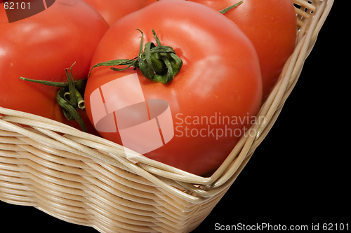 Image of Basket with tomatoes on black background with clipping path