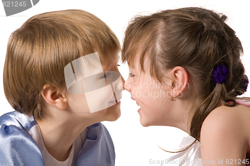 Image of Two smiling little girls sit face to face