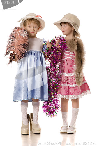 Image of Two little girls with tinsel, feather and fur