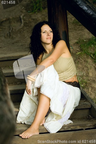 Image of attractive woman on wooden stairs