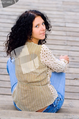 Image of woman sitting on wooden floor