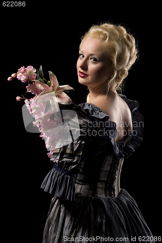 Image of Beautiful young woman with flowers on black background