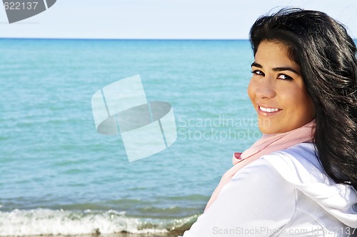 Image of Beautiful young woman at beach