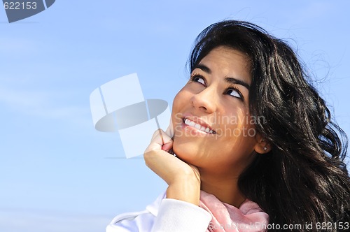 Image of Beautiful young woman looking up