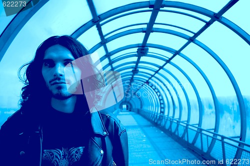 Image of long-haired men in blue tunnel