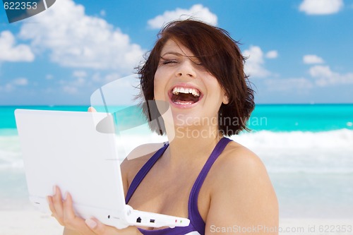 Image of woman with laptop computer on the beach