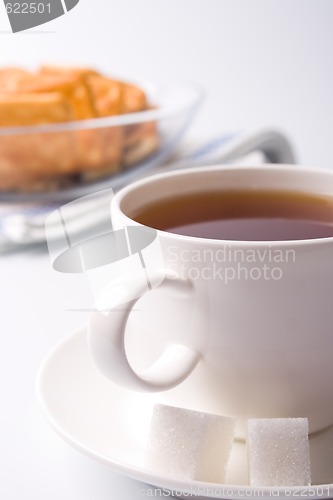 Image of cup of tea, sugar and cookies